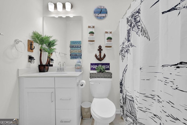 bathroom featuring vanity, curtained shower, and toilet