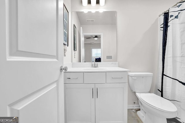 bathroom featuring tile patterned flooring, vanity, ceiling fan, and toilet