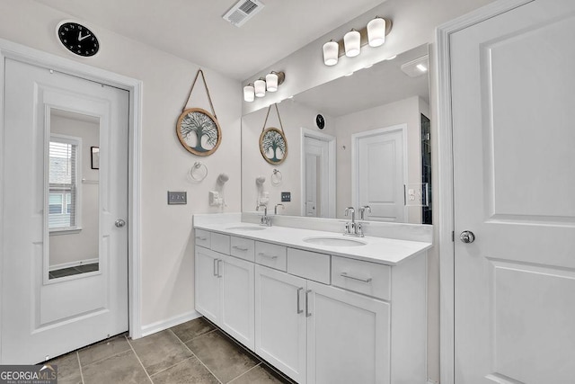 bathroom featuring tile patterned flooring and vanity