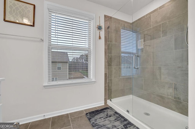 bathroom featuring tile patterned flooring and a shower with shower door