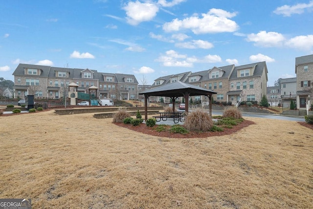 view of property's community with a playground, a gazebo, and a lawn