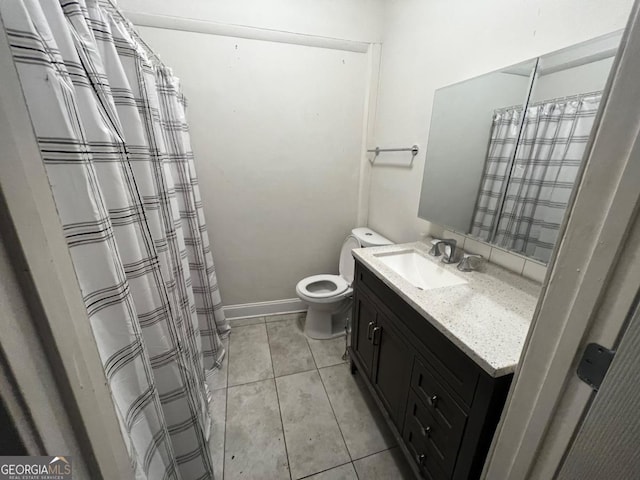 bathroom with tile patterned floors, vanity, and toilet