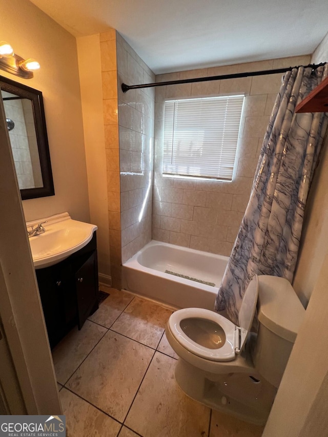 full bathroom featuring tile patterned floors, toilet, shower / bath combo with shower curtain, and vanity