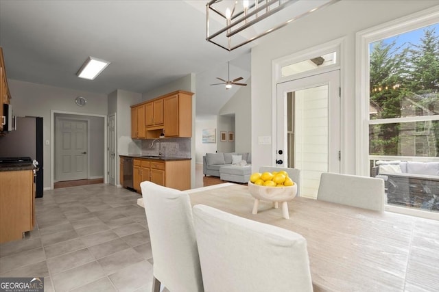 dining space with ceiling fan, a healthy amount of sunlight, and sink