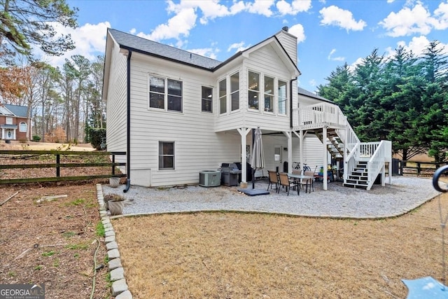 back of property with central AC, a patio area, and a deck