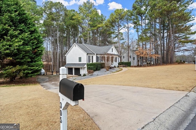 view of front facade with a garage, an outdoor structure, and a front yard