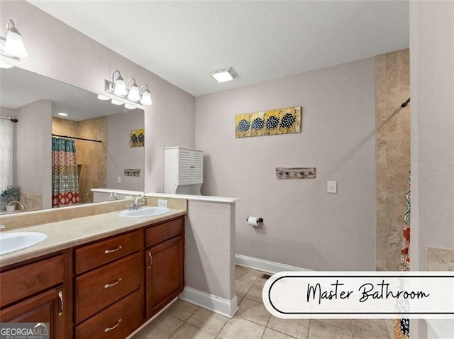 bathroom with tile patterned flooring, vanity, and curtained shower