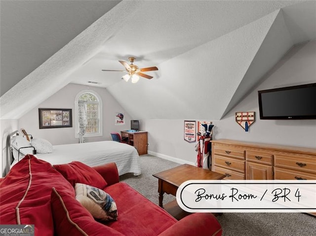 carpeted bedroom with ceiling fan, lofted ceiling, and a textured ceiling