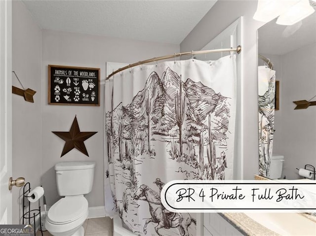 bathroom featuring vanity, toilet, tile patterned flooring, and a textured ceiling