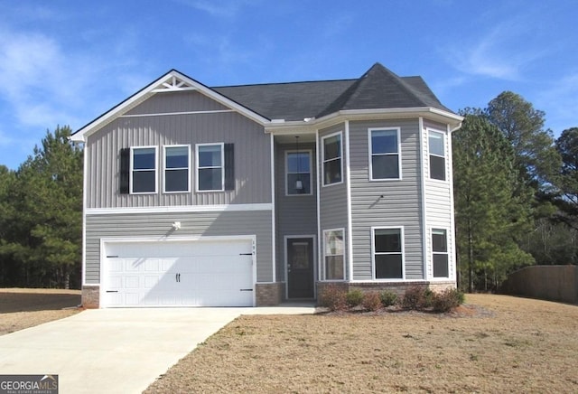 view of front of home with a garage and a front lawn