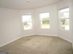 unfurnished room featuring carpet flooring