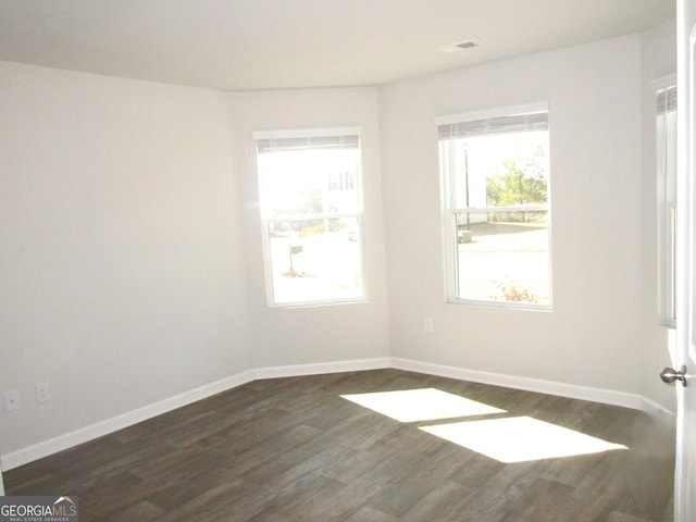 spare room with dark hardwood / wood-style flooring