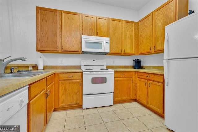 kitchen with sink, light tile patterned floors, and white appliances