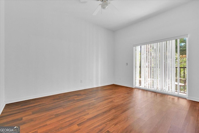 spare room featuring dark hardwood / wood-style floors and ceiling fan