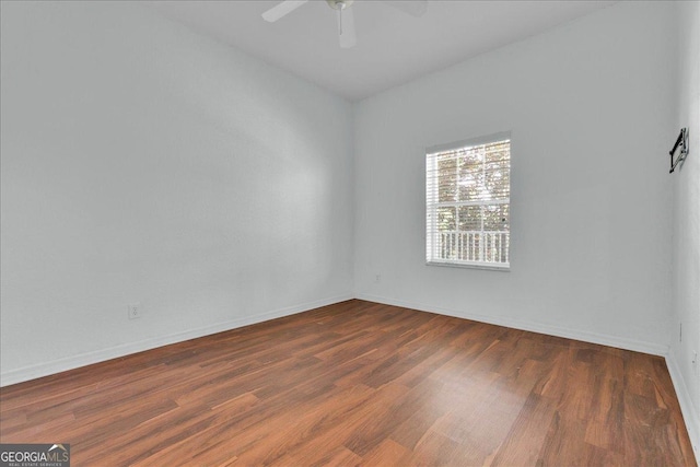 unfurnished room featuring dark hardwood / wood-style flooring and ceiling fan