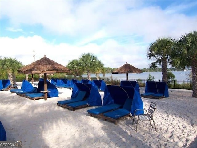 view of pool with a gazebo and a water view