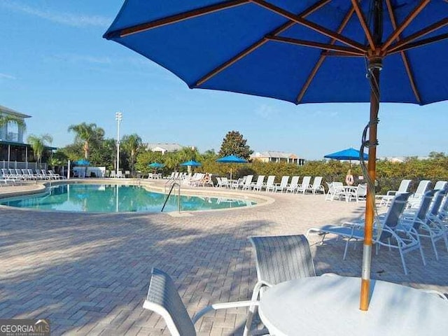 view of swimming pool featuring a patio area