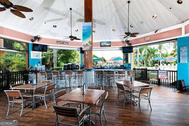 exterior space featuring high vaulted ceiling, dark hardwood / wood-style floors, and ceiling fan