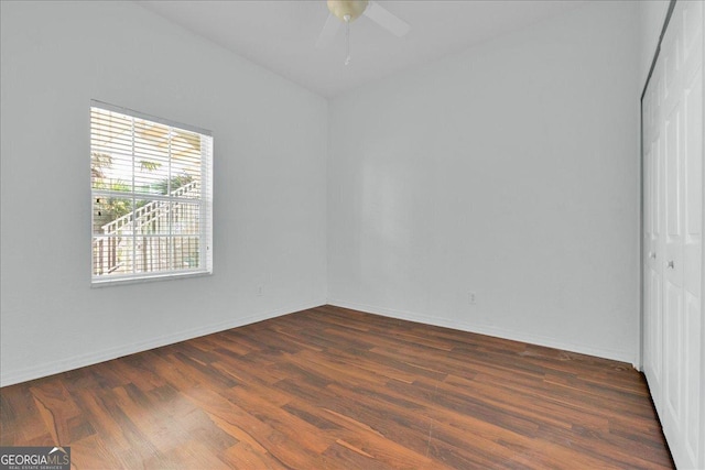 unfurnished room featuring dark hardwood / wood-style flooring and ceiling fan