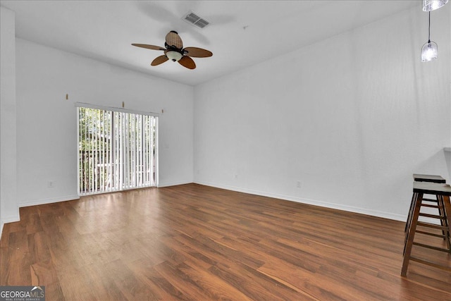 unfurnished living room with ceiling fan and dark hardwood / wood-style floors