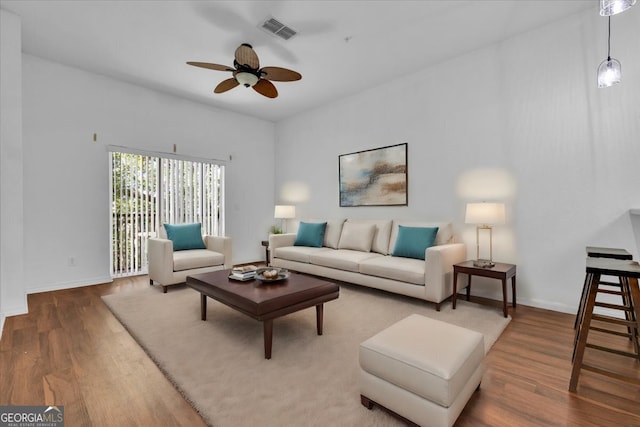 living room with ceiling fan and wood-type flooring