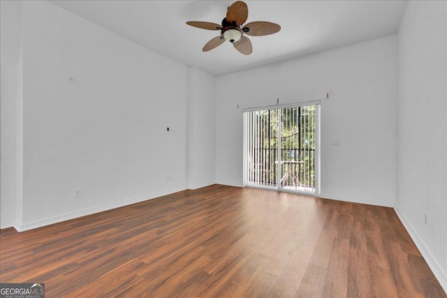 spare room featuring ceiling fan and dark hardwood / wood-style flooring