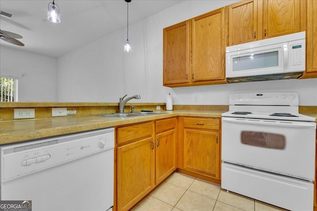 kitchen with sink, light tile patterned floors, white appliances, and decorative light fixtures