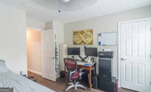 bedroom featuring dark wood-type flooring