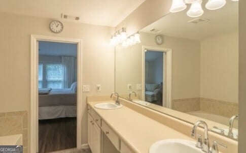 bathroom featuring vanity and a bath