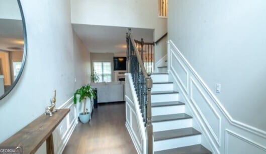 staircase with hardwood / wood-style floors