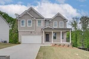 view of front of home featuring a garage and a front yard