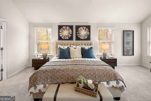 carpeted bedroom featuring vaulted ceiling