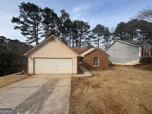 ranch-style house featuring a garage and a front yard