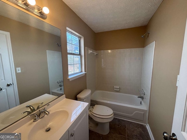 full bathroom with tile patterned flooring, tiled shower / bath combo, vanity, a textured ceiling, and toilet