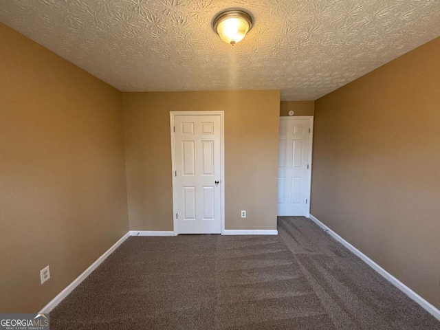 unfurnished room featuring carpet flooring and a textured ceiling