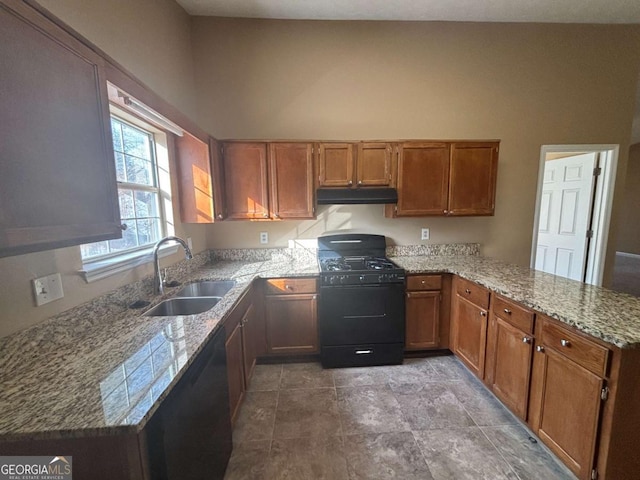 kitchen featuring sink, light stone counters, kitchen peninsula, black gas range, and a high ceiling