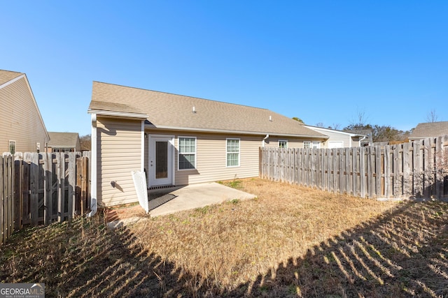 back of house with a patio and a yard