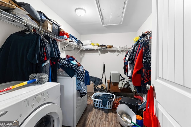 clothes washing area featuring wood-type flooring and independent washer and dryer