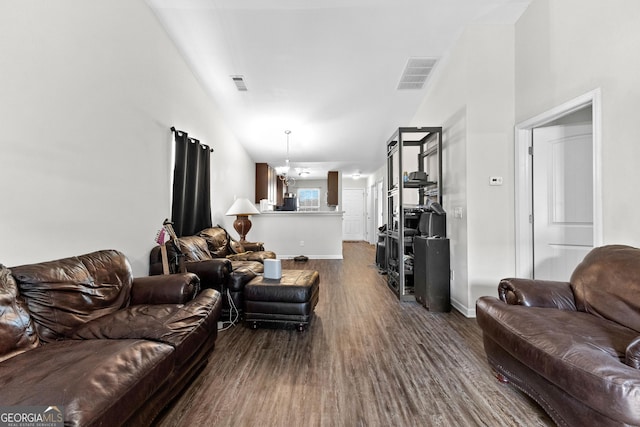 living room featuring wood-type flooring and a notable chandelier