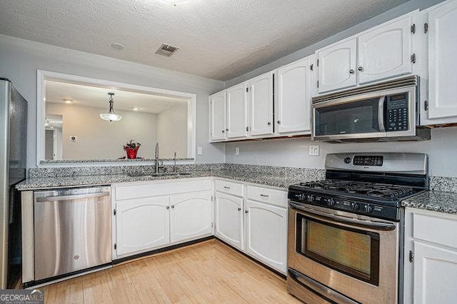 kitchen featuring white cabinetry, sink, and appliances with stainless steel finishes