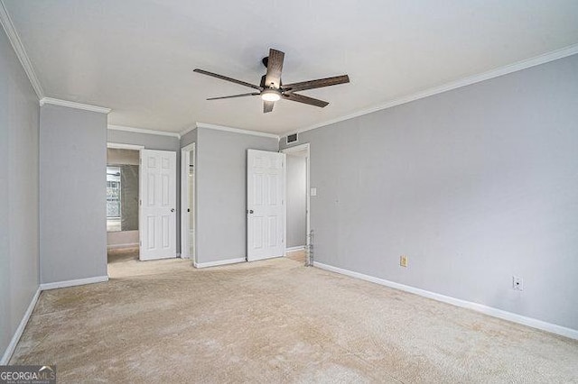 unfurnished bedroom featuring ceiling fan, light colored carpet, and ornamental molding