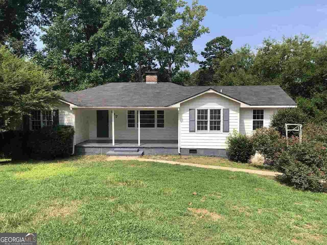 ranch-style house with a porch and a front lawn