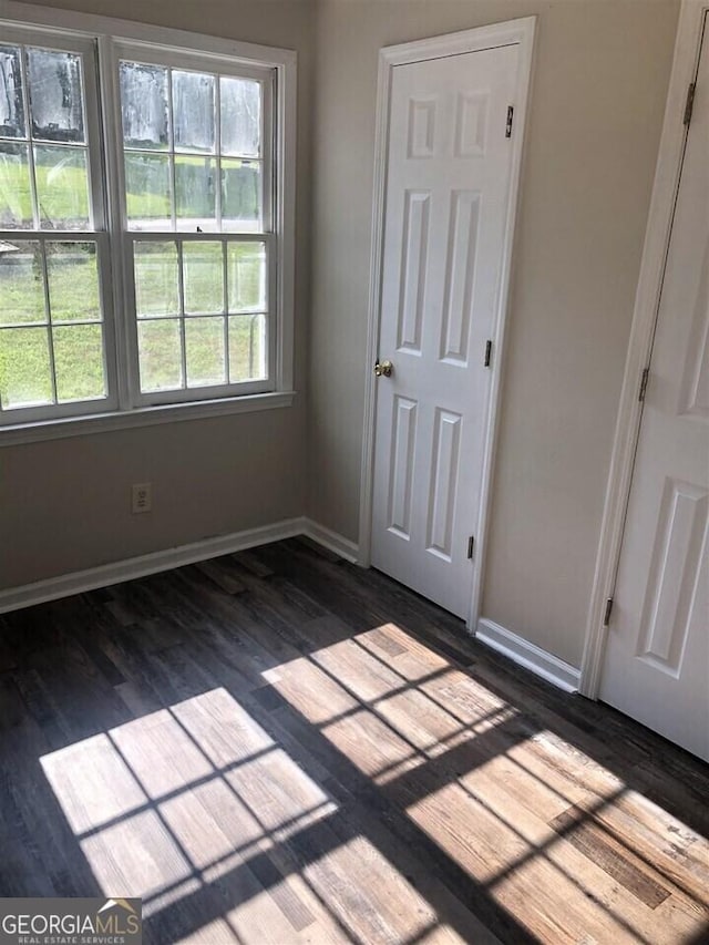 spare room featuring dark hardwood / wood-style floors