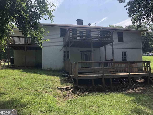 back of house featuring a yard and a deck