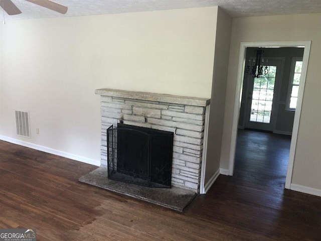 interior details with hardwood / wood-style flooring, a fireplace, a textured ceiling, and ceiling fan