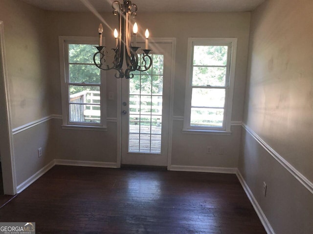 entryway with dark hardwood / wood-style floors and a chandelier