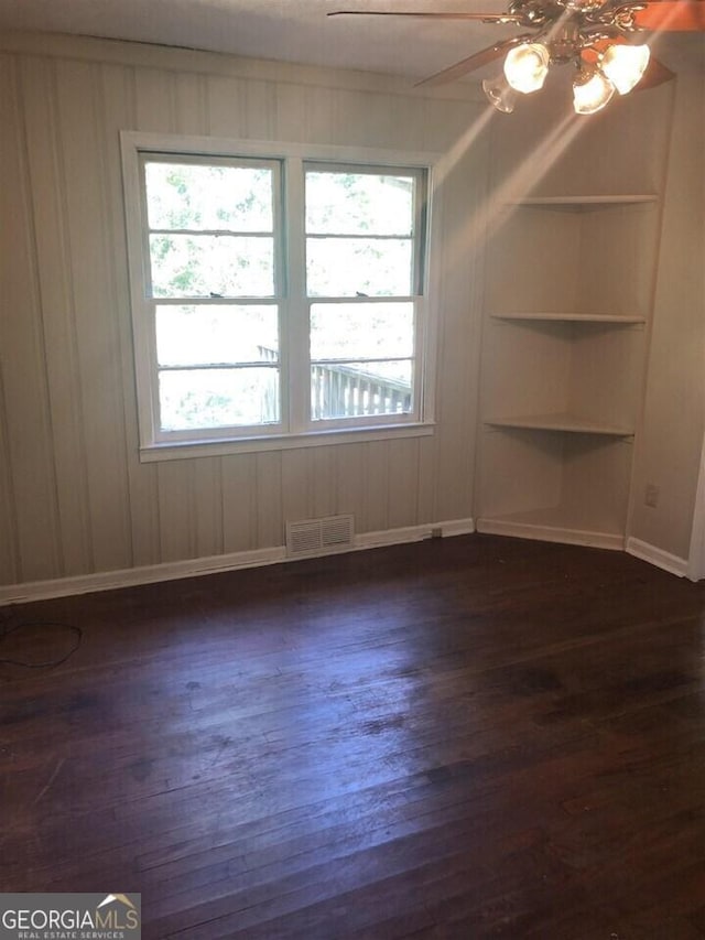 empty room featuring dark wood-type flooring