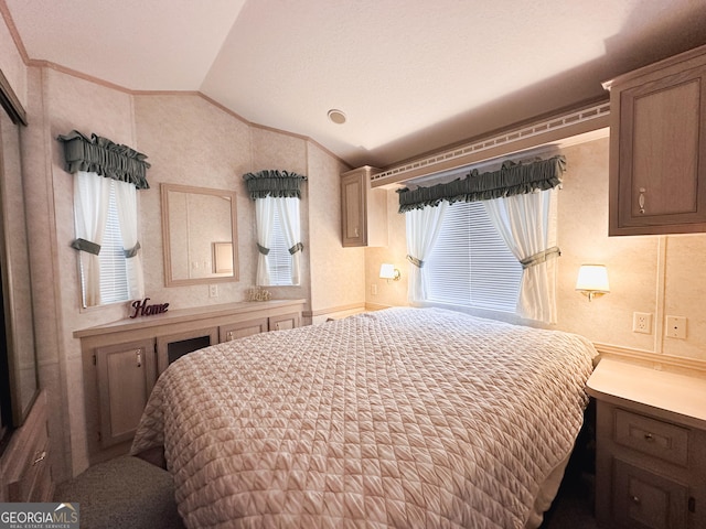 bedroom featuring lofted ceiling, crown molding, and multiple windows