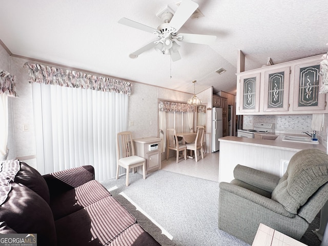 living room with lofted ceiling, sink, crown molding, ceiling fan, and a textured ceiling