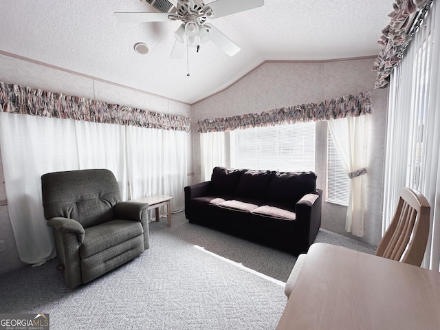 carpeted living room featuring ceiling fan, vaulted ceiling, and a textured ceiling